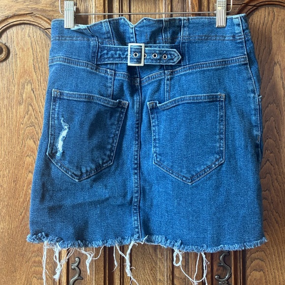 Free People distressed denim mini skirt with a buckle back and raw hem. - Picture 4 of 16